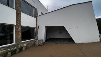 A modern building with a stone facade and large windows.