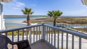 A balcony with a view of a beach and a pool area. - Calvert Castle, Elevator, Golf cart, Beach ,Pool (gulf shores)