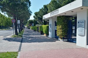 A pathway leading to a building with a sign reading "THERME".