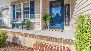 A house with a blue door, a bench, and a welcome mat. - Isle of the Pines, 1 mile from The Village of Pinehurst! (Pinehurst)