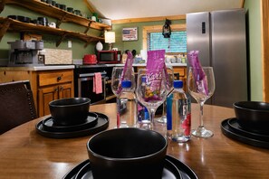 A kitchen with wooden shelves, a coffee maker, a microwave, and a refrigerator. - Walkable Pigeon Forge Escape + Hot Tub (Pigeon Forge)