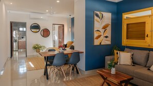 A modern living room with a dining area, a sofa, and a wooden coffee table. - Mare Lindo studio near Malecon Progreso (Progreso)
