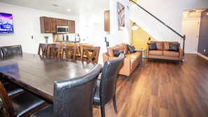 A modern interior with a dining area, kitchen, and living space.
