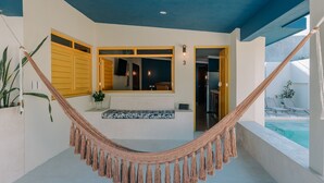 A hammock in a modern room with a view of a pool. - Mare Lindo open studio near Malecon Progreso (Progreso)