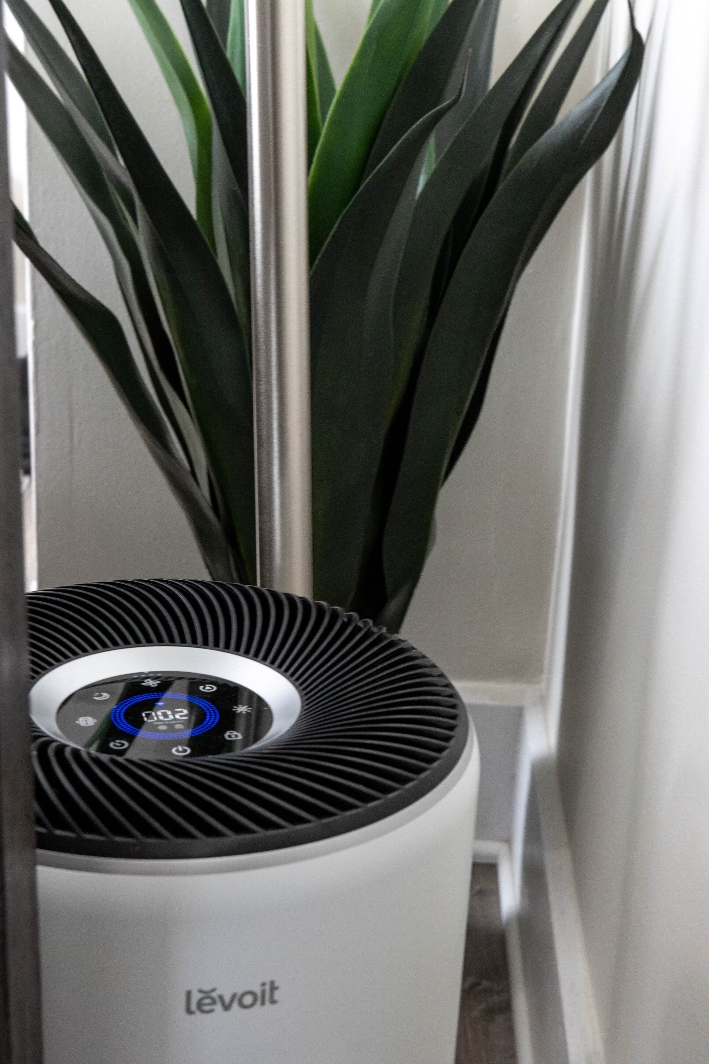 A white air purifier with a digital display and the brand name 'levoit' visible.
