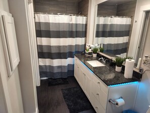 Combined shower/bathtub, towels, soap, toilet paper