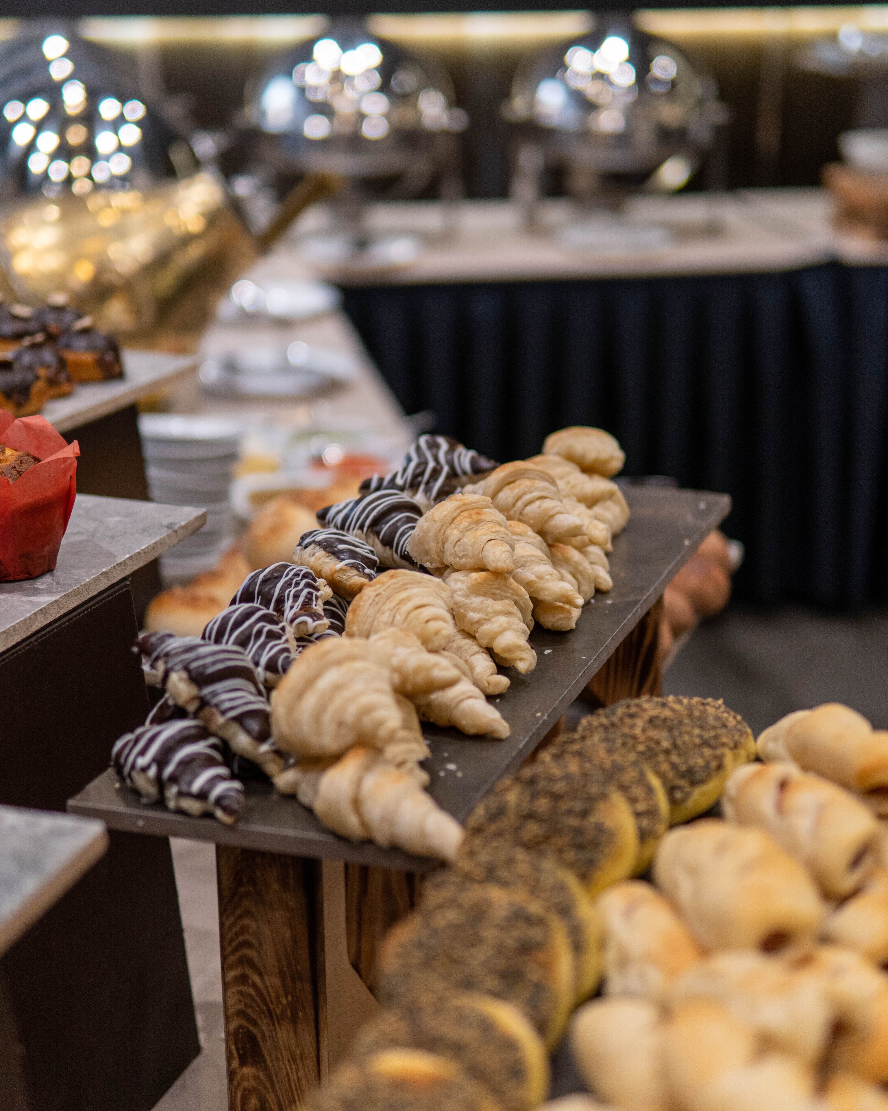 A buffet table with various pastries and desserts.