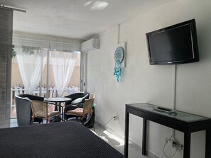 Relax in this serene space with a large bed, flat-screen TV, and cozy seating area.