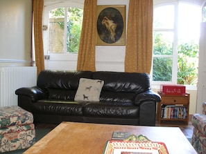 Relax in this inviting living room with a comfortable sofa, coffee table, and bookshelf.