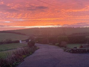 A rural landscape with a paved path leading through fields and a stone wall. - Cosy Annexe Sleeps 4 (Holyhead)