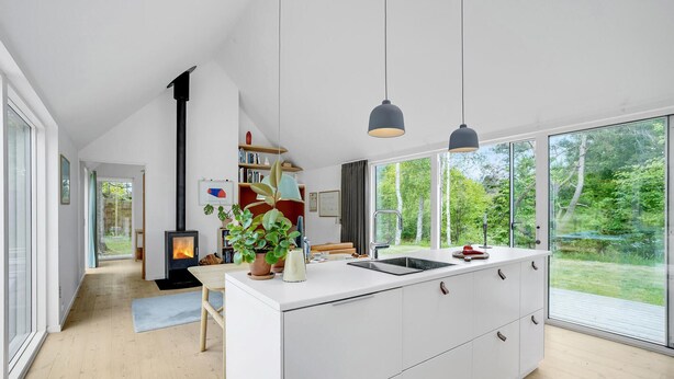 A modern kitchen with a central island, pendant lights, and a view of the outdoors. - Awesome home in Fårevejle with kitchen (Fårevejle)