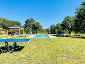 A swimming pool with lounge chairs and a pavilion in a grassy area. - 4* Holiday Home with aircon and Private Heated 10x4 Pool - 5 Mins from Monpazier (Capdrot)