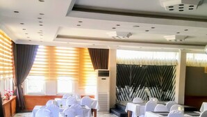 A banquet hall with tables set for a formal event, featuring a marble floor and a high ceiling with recessed lighting. - Engin Hotel (Gallipoli)