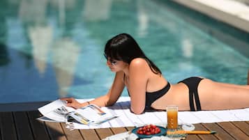 Seasonal outdoor pool, open 9:00 AM to 9:00 PM, pool umbrellas