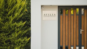 A modern building entrance with a sign reading "AVILIA LUXURY SUITES". - Avilia Suites (Fethiye)