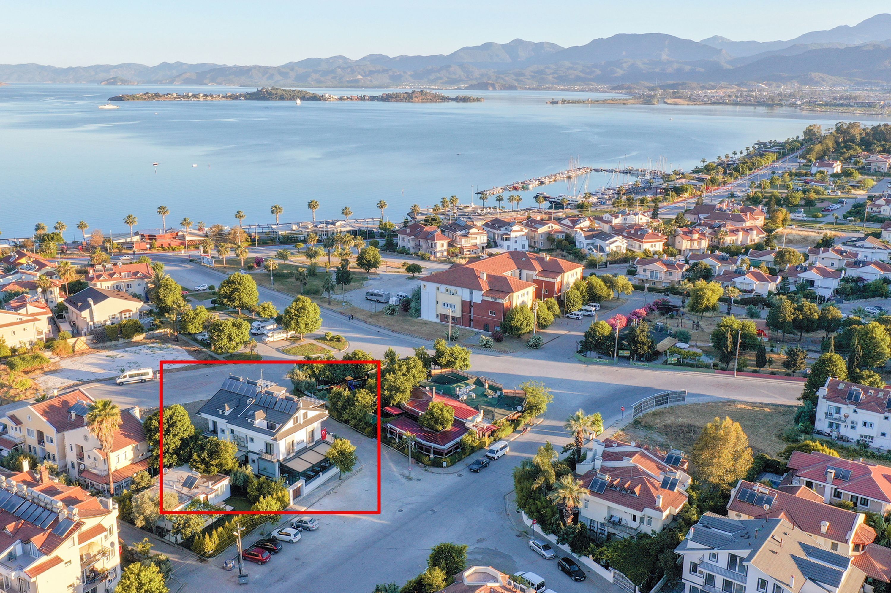 A residential area with houses, a marina, and a body of water.