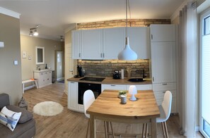 Fridge, stovetop, dishwasher, coffee/tea maker