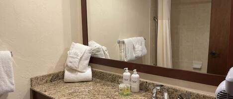 Shower, hair dryer, towels, shampoo