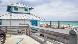 A beachside building with a ramp and a wheelchair-accessible sign. - Tradewinds 14 - Updated Gulf-View Condo, Community Pool, Beach Service Included! (Miramar Beach)