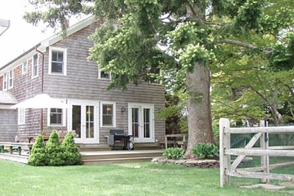 Back of house with full deck, pool fence off to the right