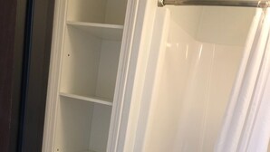 A bathroom with a toilet, a bathtub, and a shower curtain.