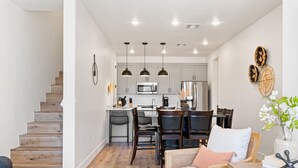 A modern kitchen with wooden cabinets, a central island, and pendant lighting. - Sun & Fun #89 by RedAwning (St. George)