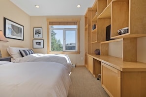 A bedroom with two beds, a wooden desk, and a window with a view. - 3 BR 2 BA Ski-in & Ski-out, 50 steps to ski run, unbelievable location! (Mammoth Lakes)