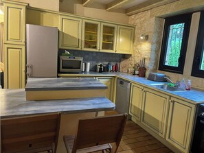 Enjoy cooking and dining in this well-equipped kitchen with a central island and bar seating.