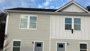 A two-story building with a symmetrical facade, multiple windows, and a central entrance. - SC (3745) 2BDR Townhouse Ft Jackson.   (Columbia)