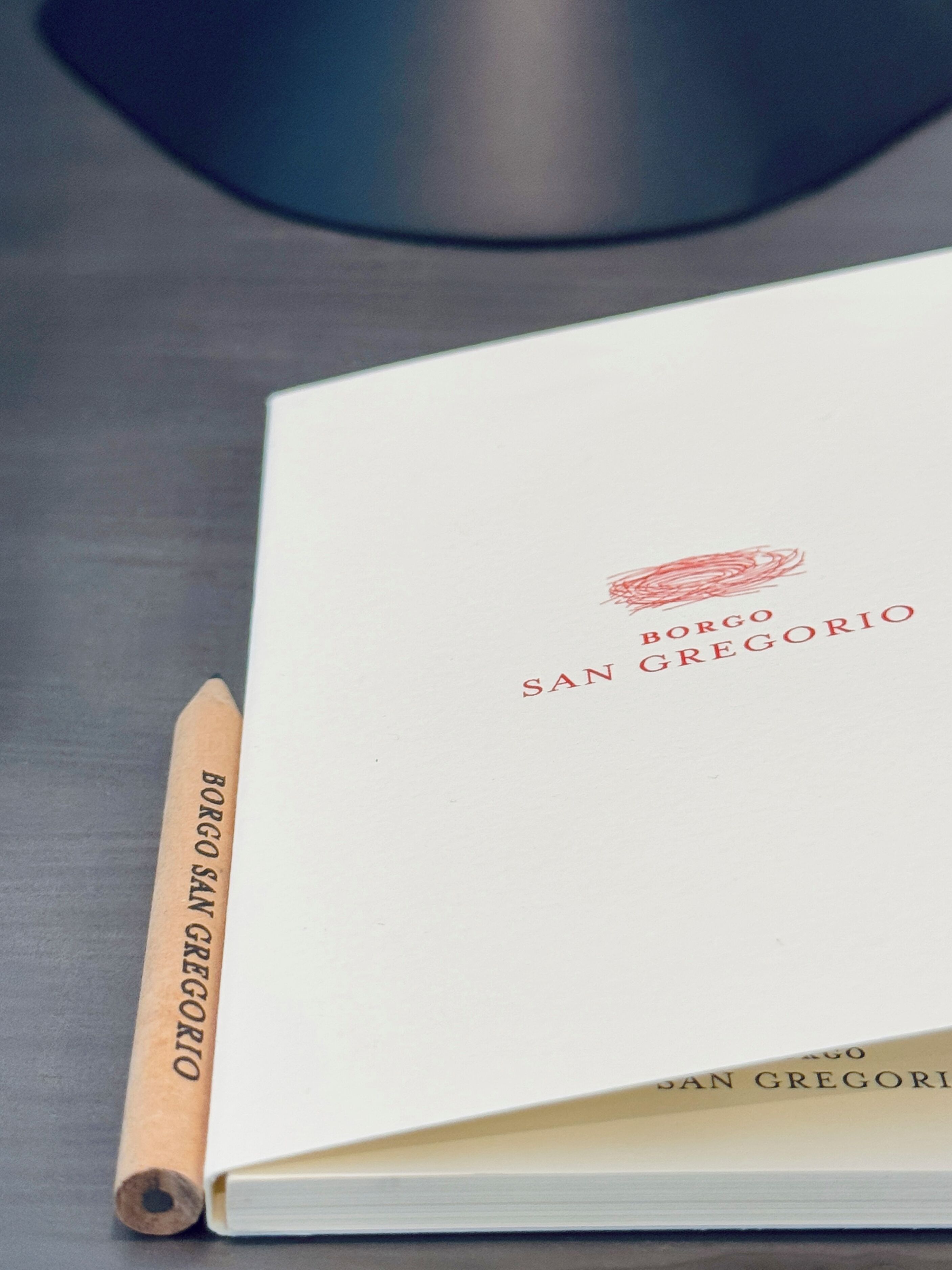 A book titled "Borgo San Gregorio" on a table.
