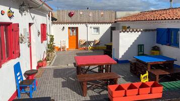 A courtyard with outdoor seating, a door, and a small table.