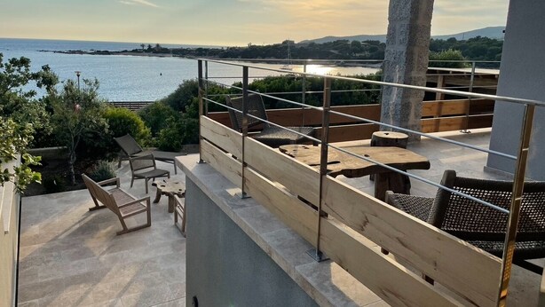 A rooftop terrace with outdoor seating, a view of the sea, and a sunset. - Beachfront villa. (Sartène)