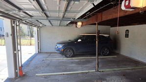 Un estacionamiento con una camioneta SUV azul en su interior.