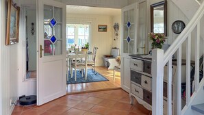 A spacious room with a dining area, a staircase, and a view of the outdoors. - Gorgeous home in Fjell with WiFi (Fjell)