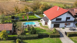 A house with a red roof, a swimming pool, and a well-maintained garden. - Awesome home in Gudovac (Gudovac)