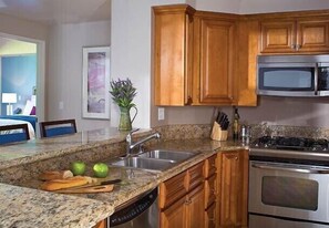 Enjoy cooking in this well-equipped kitchen with a microwave, oven, and dishwasher.