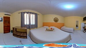 A room with a large bed, a small desk, a chair, a TV, and a window with curtains. - POUSADA SONHO DE MAR (Luis Correia)