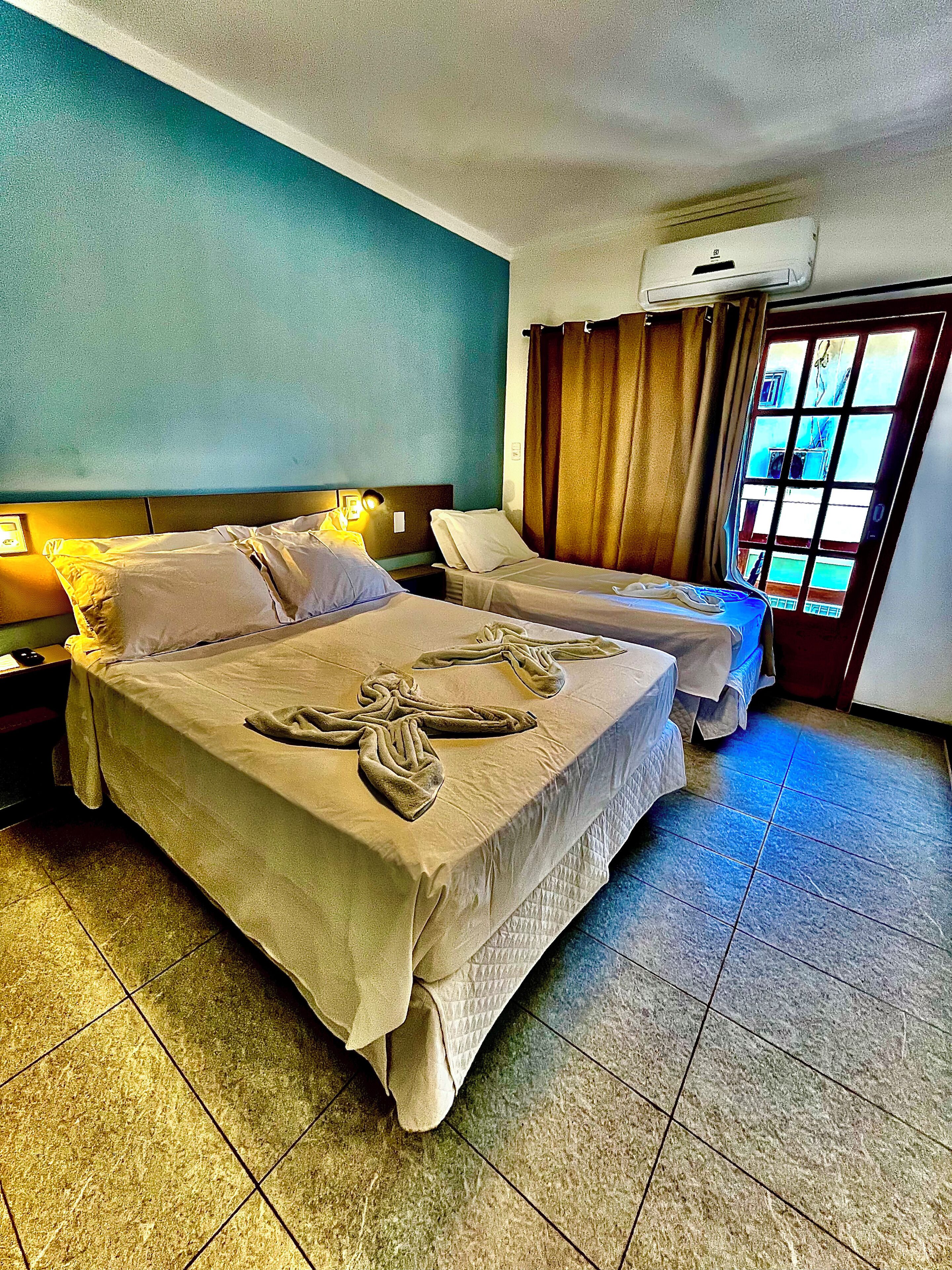 Triple Room, Patio | Desk, laptop workspace, blackout drapes, iron/ironing board