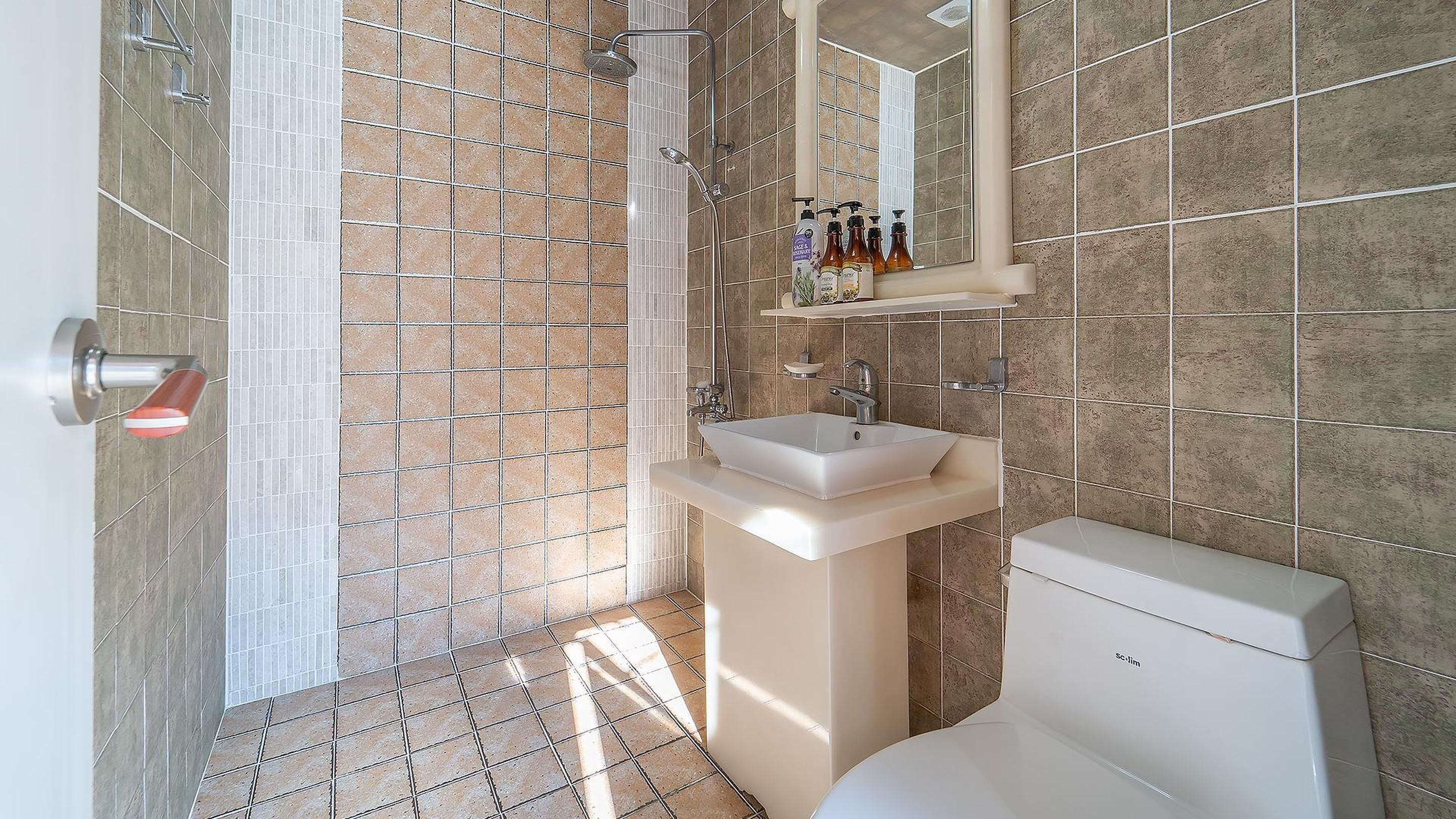 Un baño con ducha, lavabo e inodoro.