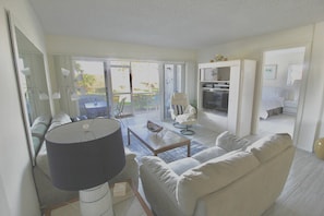 Relax in this inviting living room with a comfortable sofa, coffee table, and dining area, perfect for enjoying meals and conversation.