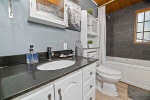 Combined shower/bathtub, towels, toilet paper