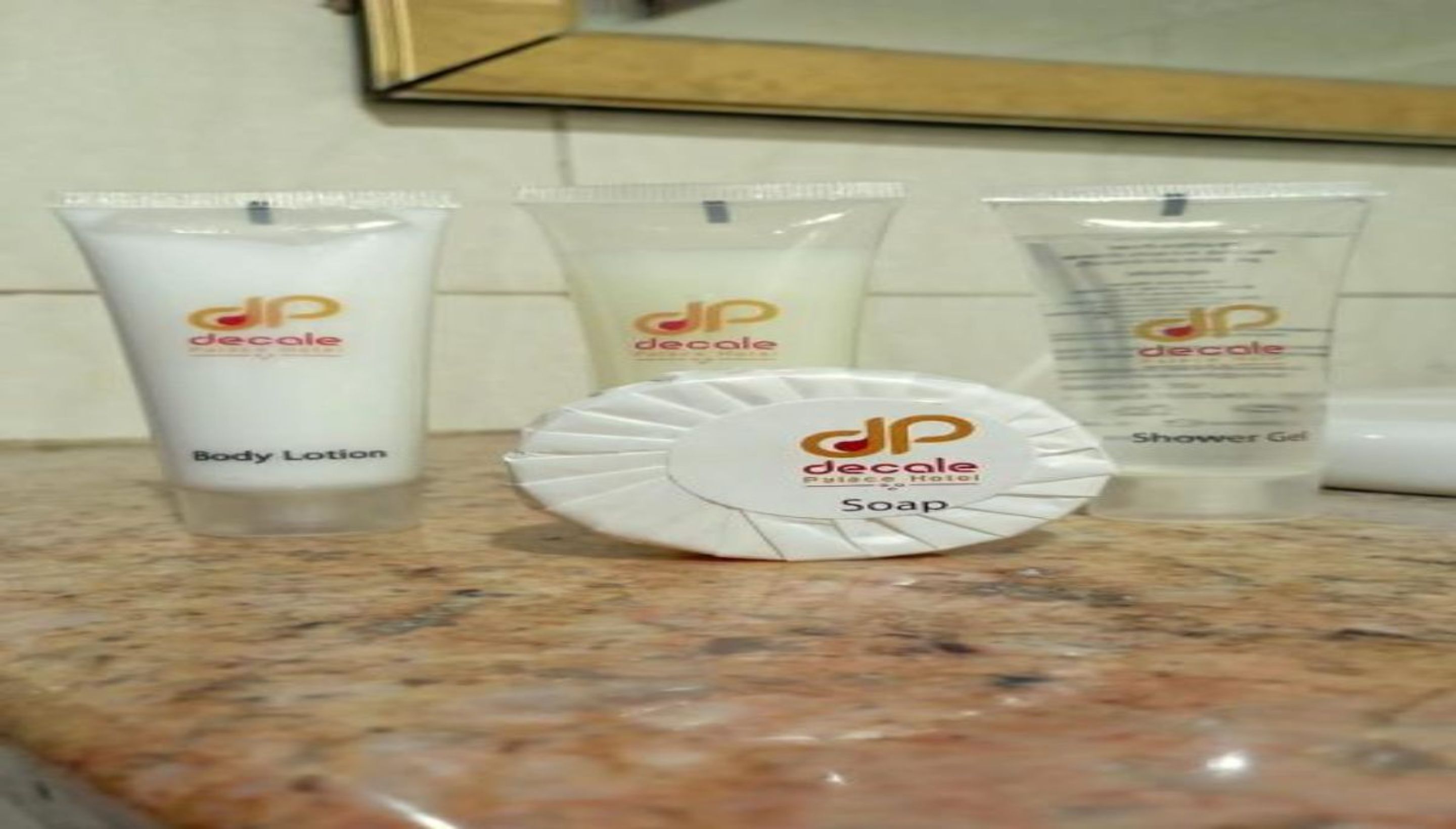Tres productos de cuidado corporal Decale: loción corporal, jabón y gel de ducha.