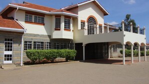 A two-story building with a balcony, large windows, and a red-tiled roof. - Kusyombunguo Hotel Lukenya (Athi River)