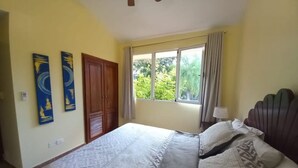 A bedroom with a bed, a window with curtains, and a door. - "las Brisas, Juan Dolio, 3 Bedrooms, 3 Pools, Jacuzzi, Beach, Golf,polo" (Guayacanes)