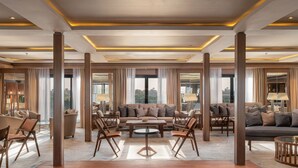 A spacious hotel lobby with a central seating area, large windows, and a modern ceiling design. - JAZ  Elite Viceroy Nile Cruise - Every Saturday from Luxor for 07 & 04 Nights - Every Wednesday From Aswan for 03 Nights (Luxor)