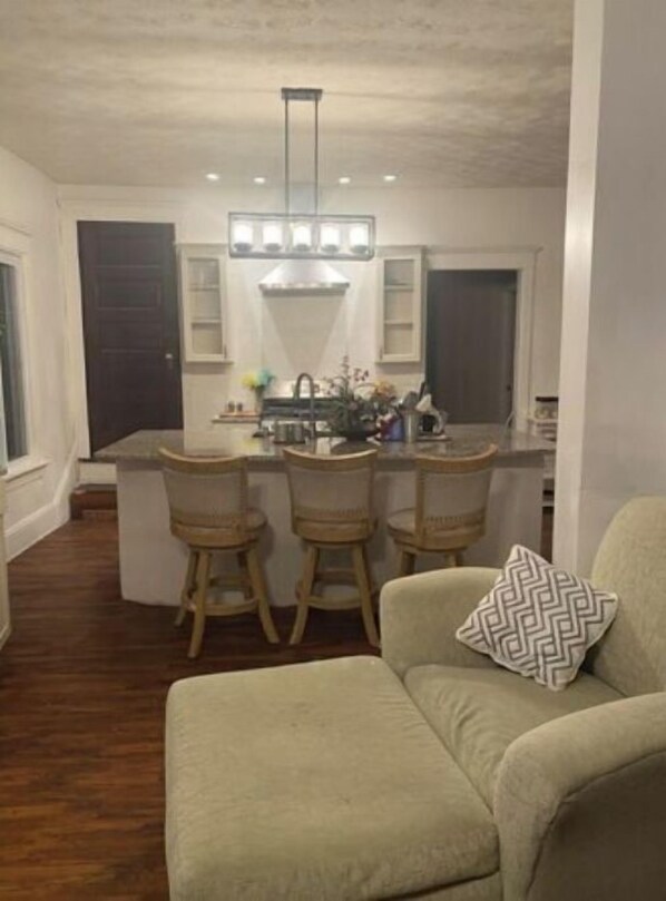 Relax in this cozy space with a central island and bar stools, perfect for a home away from home.