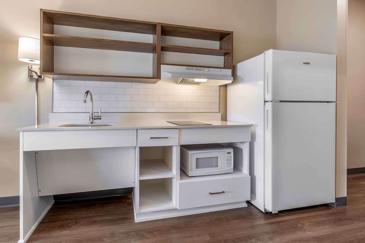 laptop workspace, iron/ironing board, bed sheets