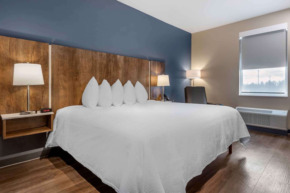 laptop workspace, iron/ironing board, bed sheets