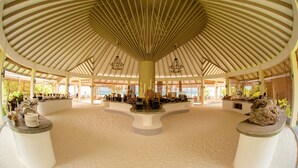 A spacious indoor area with a high, slanted ceiling and a central island. - Hondaafushi Island Resort (Hondaafushi)