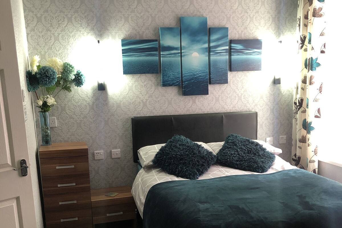 Family Room | Desk, blackout drapes, iron/ironing board, bed sheets